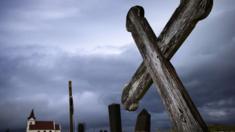 This picture taken on July 10, 2014 shows a cross in the cemetery and the church of Kjalvegur, southwest Iceland.