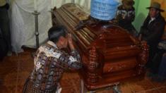 A man cries over the coffin of Mayor Bacilio Juracan on 12 October, 2015.
