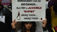 An Indian protester holds a placard during a demonstration against the release of a juvenile rapist in New Delhi on December 21, 2015