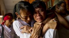 Newly-released political student protester and family members cry after being reunited in Tharrawaddy town, Bago Region in Myanmar on April 8, 2016