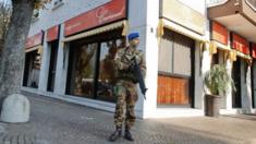 An Italian soldier patrols outside a Kosher restaurant