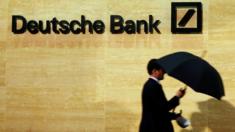Man walks past Deutsche Bank office