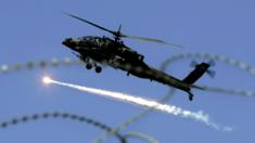 A U.S. military Apache helicopter releases an anti missile decoy flare as it flies over Baghdad, Iraq, Thursday, Feb. 15, 2007.