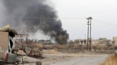 Smoke rises from the town of Bashiqa as government forces continue their offensive on Mosul, 10 November 2016