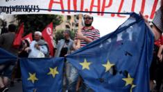 Demonstrators destroy a European flag during a rally by supporters of a 