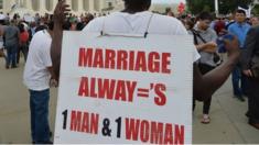 A man protests gay marriage outside the Supreme Court.
