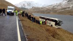 Passengers are led off the crashed coach