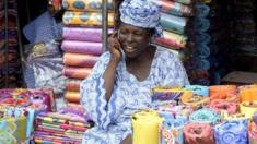 A shop owner makes a call at Oshodi market in Lagos, Nigeria - 25 February 2015