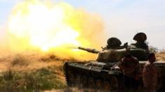 Fighters from the Fajr Libya (Libya Dawn), an alliance of Islamist-backed militias, take cover as during clashes with an opposing militia in Bir al-Ghanam, around 50 kilometres (30 miles) from the capital on March 19, 2015