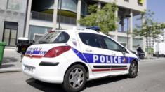 A police vehicle is parked outside the student residence where an It student, suspected of planning a church attack in France, lived in Paris on April 22, 2015