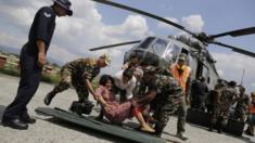 A woman injured in Saturday’s earthquake, is laid on a stretcher after being evacuated in an Indian Air Force helicopter at the airport in Kathmandu, Nepal, Monday, April 27, 2015.