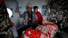 Injured residents sit inside an India Airforce helicopter as they are evacuated following Saturday"s earthquake in Sindhupalchowk, Nepal, April 28, 201