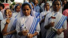 Indian nuns and residents take part in a vigil and protest against the gang-rape of a nun at a convent-school in Kolkata on March 16, 2015