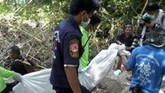 Thai rescue workers carry a recovered body