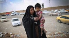 Displaced mother and child at a checkpoint in Kalak, Iraq