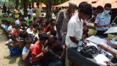 Rohingya men register for Indonesian immigration documentation at confinement area at Bayeun, Aceh province. 21 May 2015