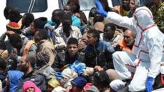 An Italian Coast Guard ship carrying migrants arrives at Pozzallo"s harbor near Ragusa, Sicily, Italy, Tuesday, May 19, 2014.