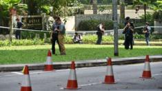 Singapore police investigators inspect the crime scene near the Shangri-La hotel in Singapore on 31 May 2015