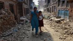 Schoolgirl Ankita Kapali, 11, walks with her mother past damaged buildings to school in Bhaktapur, near Kathmandu. Photo: 31 May 2015