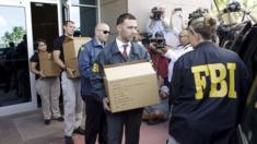 FBI investigators remove documents after the arrests of several senior Fifa officials