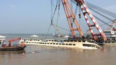 Rescuers turn around the cruise ship Dong Fang Zhi Xing which capsized in the Yangtze River in Jianli county