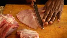 A man slicing pork