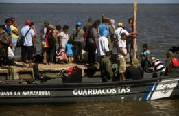 Habitantes de la Isla de Toas esperan en un embarcadero.