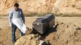 Man standing near grave