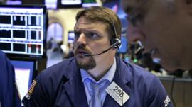 Traders work on the floor at the New York Stock Exchange in New York - 8 July 2015