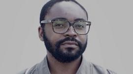A black man with glasses
