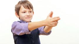 Boy shooting using his hands