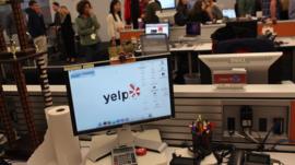 Employees of the online review site Yelp watch as New York City Mayor Michael Bloomberg speaks at the new East Coast headquarters of the tech company on October 26, 2011