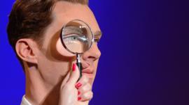 Close up of Benedict Cumberbatch with magnifying glass