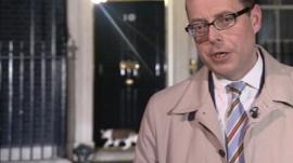 Larry the cat (L) and the BBC's Nick Robinson (R) in Downing Street