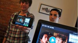 The creators of Video Time Machine holding an iPhone and iPad