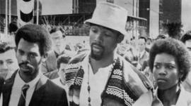 John Carlos (centre) leaving Mexico 1968 Olympic Village