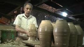 A man throwing a pot