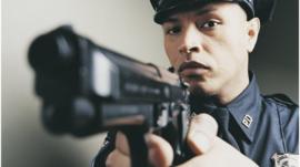A US police offer holding a gun