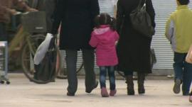 Family walking down street
