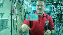Astronaut Chris Hadfield with the new note floating in space