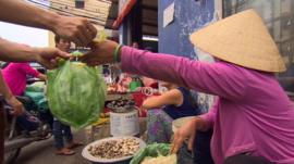 Woman selling lettuce in Vietnam