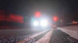 Kerb with headlights in background