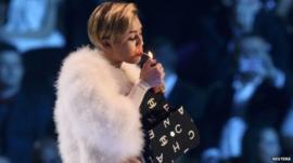 Miley Cyrus lights a cigarette on stage during the 2013 MTV Europe Music Awards