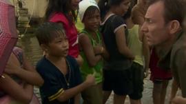 Children queue for rice