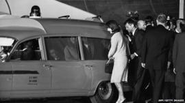 First Lady Jacqueline Kennedy and Robert Kennedy get into the Navy ambulance which carries President Kennedy's body