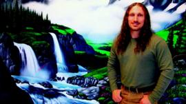 Prisoner in front of backdrop