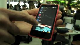 BBC Technology Correspondent Mark Gregory is shown the new Nokia X range of smartphones at the Mobile World Congress in Barcelona.