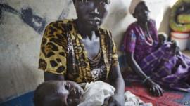 Babies are held by their mothers as they receive treatment for dehydration, vomiting and diarrhoea at a clinic run by Medecins Sans Frontieres in a school in Awerial, South Sudan, 2 January 2014