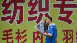 Man reading Chinese newspaper