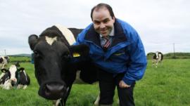 The boss of Dairymaster posing with a cow